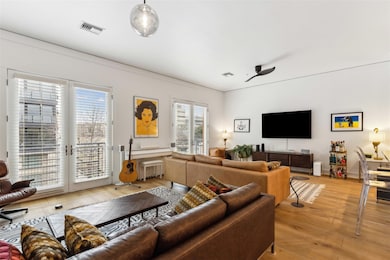Living room featuring visible vents, baseboards, l