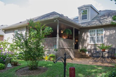 Inviting backyard with beautiful   landscaping ,patio and covered porch