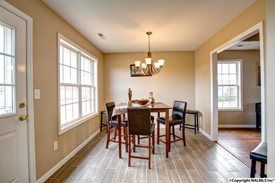 Kitchen area features new tile flooring and stylish fixtures.