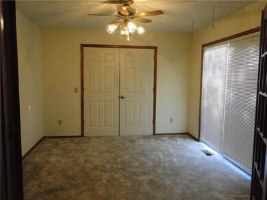 3rd Bedroom or Office space with a large closet and patio doors.