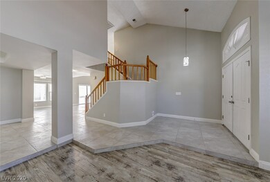 View of the stairs, front door, sunken formal livi