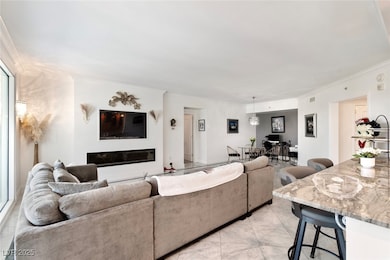 Living room featuring crown molding and light marb