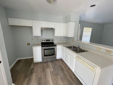 Kitchen with stainless steel electric range oven,
