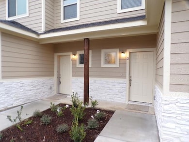 View of exterior entry featuring stone siding