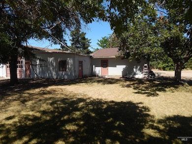 Back of house with a lawn