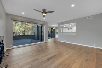 Spacious living area features hardwood floors, a c