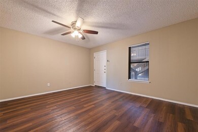 Unfurnished room with a ceiling fan, dark wood-st