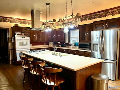 Has double wall oven, elect and gas stove top.