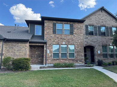 View of front facade featuring a front lawn and brick siding
