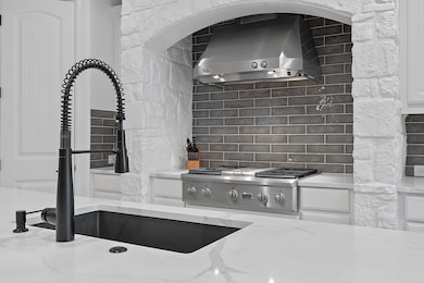 Kitchen featuring wall chimney exhaust hood, rang