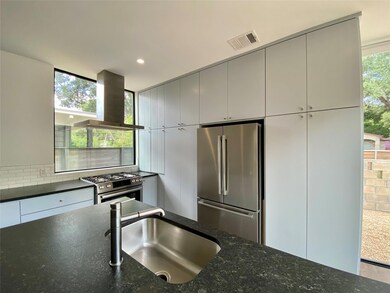 Kitchen featuring stainless steel appliances, wal