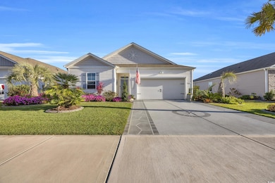 Ranch-style house with concrete driveway, a garage, and a front yard