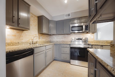 Kitchen with a sink, light tile patterned floors, 