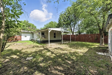 Fenced backyard with a patio