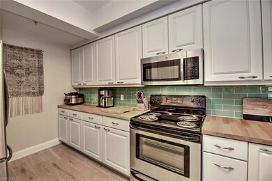 Kitchen featuring white cabinets, appliances with 
