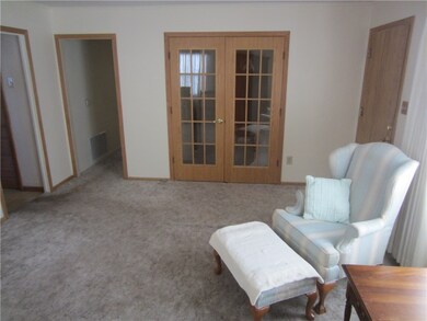 Living room facing French doors to office/bedroom.