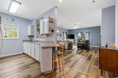 Kitchen featuring white cabinetry, wood finished f