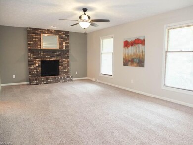 Great room with a brick fireplace.