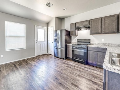 Kitchen featuring stainless steel refrigerator wit
