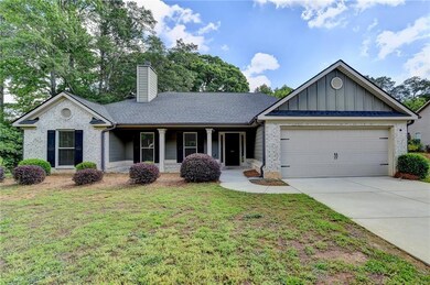 Single story home featuring a chimney, board and b