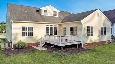 Rear view of house with crawl space, a deck, a yar