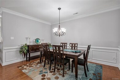 Dining room with chandelier and hardwood floors