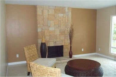 Family Room with Stone fireplace & view to backyar