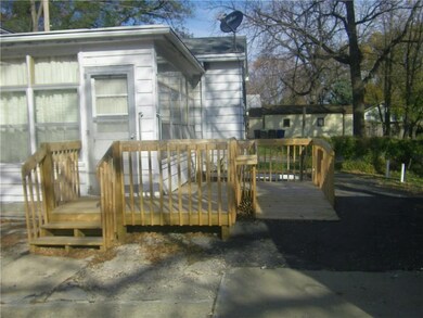 The enclosed rear porch features lots of windows, laundry hookups and a deck with ramp.