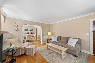 Hardwood floored living room with ornamental molding