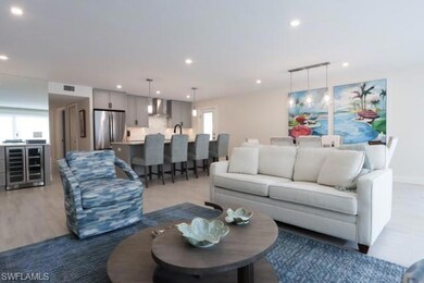 Living area featuring healthy amount of natural light, beverage cooler, light wood-type flooring, and recessed lighting