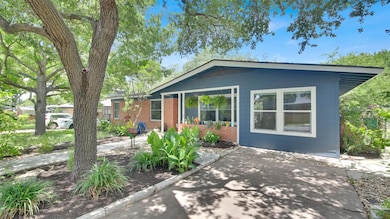 Ranch-style house with brick siding and a patio a