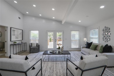 Living area featuring lofted ceiling with beams, visible vents, wood finished floors, and recessed lighting