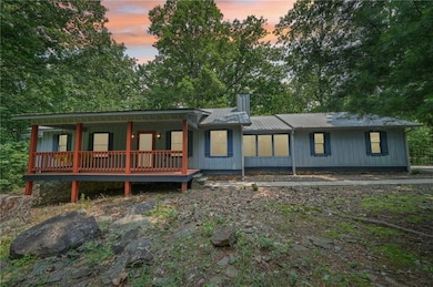 Rear view of house with a porch and metal roof