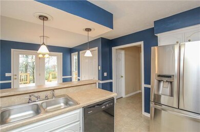 Another view of the kitchen, looking into the eating area  The SS refrigerator remains with the house