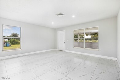 Spare room with light marble finish floors and recessed lighting