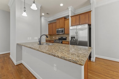 The open kitchen with convenient bar top seating b