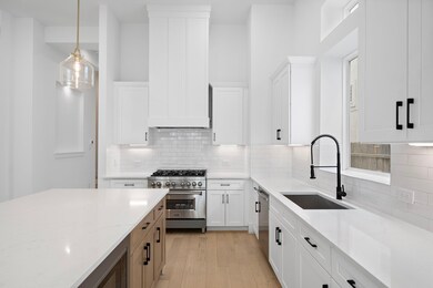 Closeup of large island kitchen with 6-burner stov