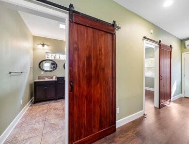 Hall bath with bypass barn doors