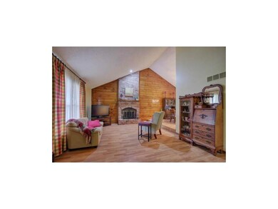 Fireplace and laminate wood flooring with large op