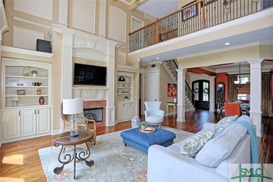Enter into the soaring two-story foyer and notice