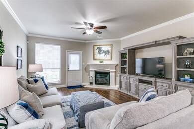 Living room with ceiling fan, ornamental molding, 