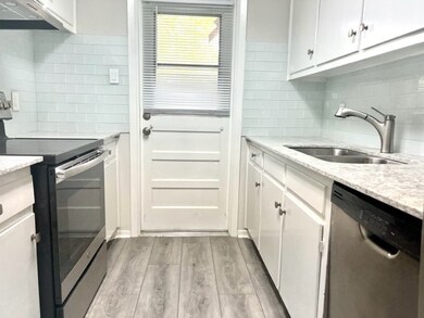 The kitchen with granite countertops, subway tile