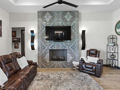 Living room featuring wood finished floors, a cei