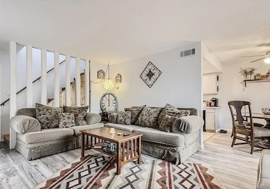 Living room with a ceiling fan and light wood-type flooring