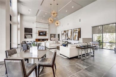 Dining space featuring a high ceiling and a chande