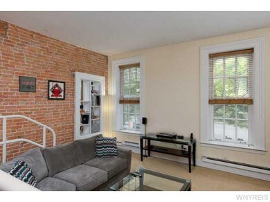 Living Room Large windows with wood blinds