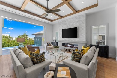 Living area featuring coffered ceiling, wood finis
