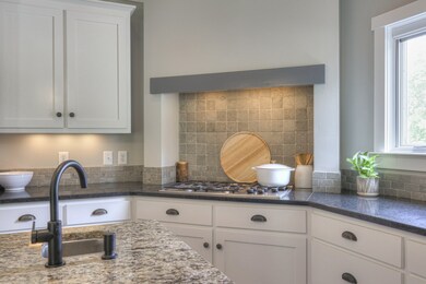 Perfect kitchen design for the chef in your house! Five burner gas cooktop and separate wall oven makes preparing meals a breeze.