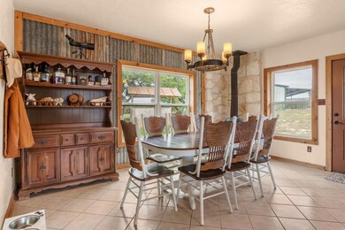 Dining room with a notable chandelier and light t