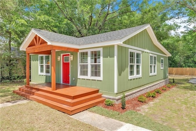View of outbuilding with fence
